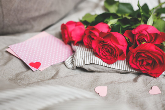 Romantic background with copy space. Beautiful roses and Valentine card with heart. Selective focus