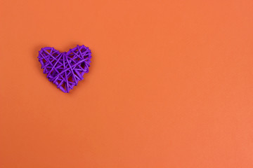 Purple heart on orange background, Valentines day.