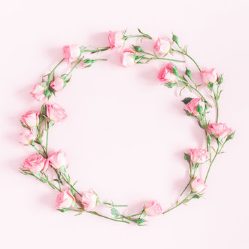 Flowers composition. Wreath made of pink rose flowers on pink background. Flat lay, top view, copy space, square