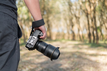 Photographer holdind camera on hand