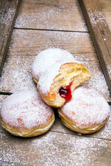 Traditional Polish donuts on wooden background. Tasty doughnuts with jam.