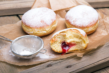Traditional Polish donuts on wooden background. Tasty doughnuts with jam. - obrazy, fototapety, plakaty