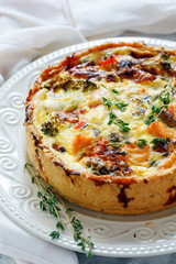 Quiche with salmon, broccoli,red pepper and thyme.