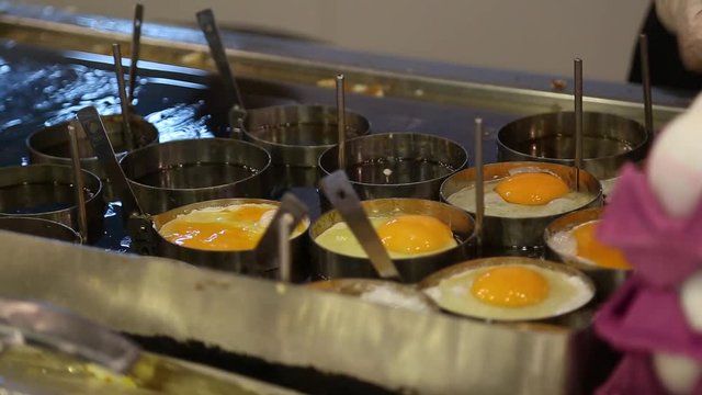 Cooking of many fried eggs at restaurant. Real time full hd video footage.
