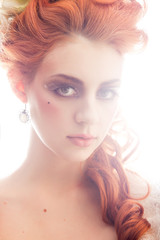 Young woman dressed in the fashion style of Rococo with vintage red hairstyle. Place for text	