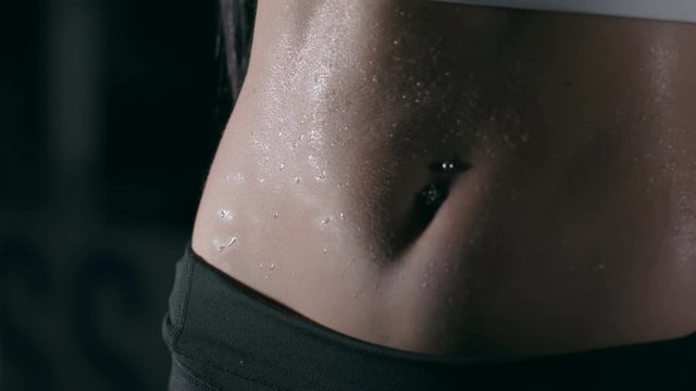The belly of a girl in a grueling workout