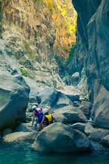 Young sportsmen move across the mountain river in Goynuk Canyon. Goynuk, Antalya province, Turkey