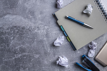 circular notebook, golden telephone, blue stapler for paper, blue elegant pen and white paper...