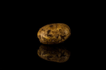 Fototapeta na wymiar Dirty potato isolated on black background.