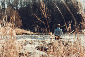 Naklejka na ściany i meble Boy fishing at river