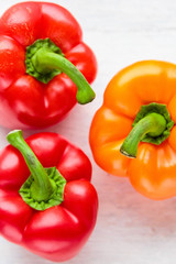 orange and red paprika on a white background