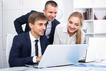 business colleagues with laptops in office .