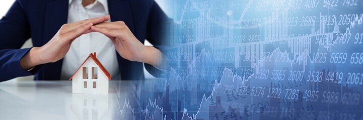 Home model under businesswoman's protective hands