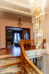 Vertical ceiling crystal chandelier, elementa of a ladder handrail.