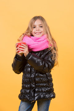 Girl with long blond hair in black jacket hold mug