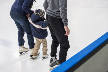 Fototapeta na wymiar Family ice skating at rink. Winter activities