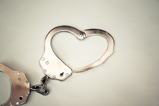 Handcuffs in a love heart with copy space to add text