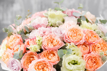 beautiful bouquet of mixed flowers in a vase on wooden table. the work of the florist at a flower shop