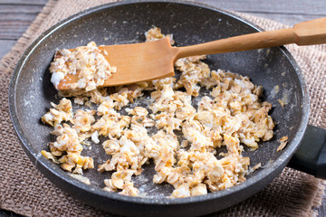 Frying egg with oatmeal in a frying pan. Healthy breakfast, healthy eating, vegan food concept.