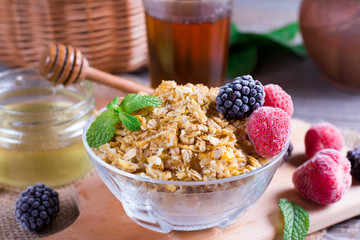 Homemade oatmeal with berries for breakfast on table, closeup