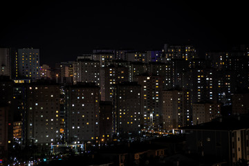 Fototapeta na wymiar Massive aparments view during the night time with its electric lights