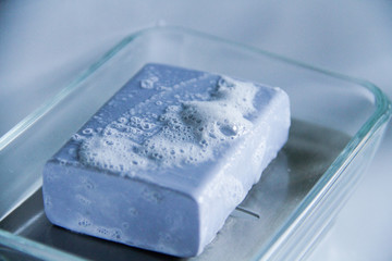 blue soap with foam on a dish on sink