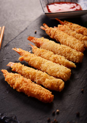 Fried shrimps on sticks in crispy coating