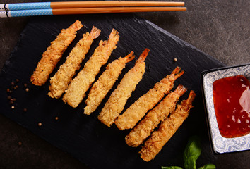 Fried shrimps on sticks in crispy coating