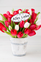 Springt time. Red tulip bouquet on the white wooden background.