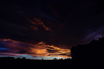 sinister dark clouds over the evening city