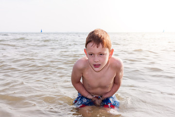 Boy shivering in sea