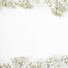 Styled stock photo. Feminine wedding desktop mockup with baby's breath Gypsophila flowers on white background. Empty space. Floral frame, web banner. Top view. Picture for blog or social media.