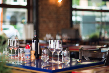 Table in brasserie with bottle of wine and glasses