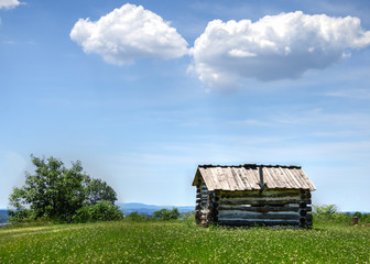 Old Log Cabin With Clouds