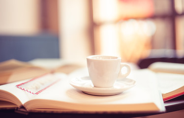 front view espresso cup on a book