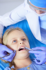 Little girl sitting in the dentists office