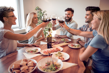 Young friends celebrate with alcohol and food
