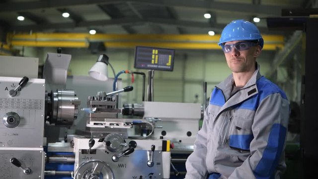 Metal Processing Worker Portrait. Worker Seating in Front of Metal Lathe. Industrial Theme