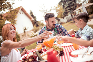 Family having lunch in the garden in summer.
