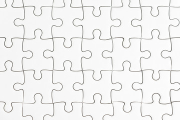 Problem solving and business solutions concept, closed up shot of white paper jigsaw puzzle using as background or wallpaper