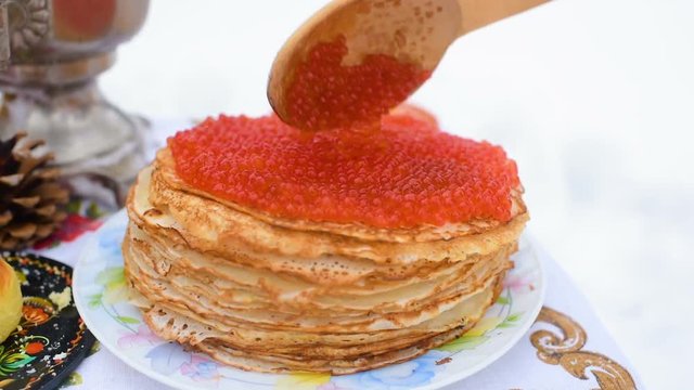 pancakes with red caviar close-up on the background of the festive table. Celebration of carnival in Russia. Maslenitsa, Shrovetide