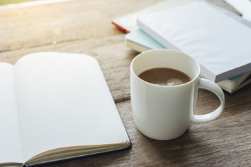 a cup of coffee with note book