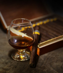 Large box of Cuban cigars on a wooden table