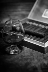 Retro styled photo of large box of Cuban cigars on a wooden tabl
