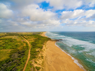 Aerial view of Australian countryside and ocean coastline at sunset