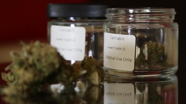 Medical Marijuana in jars rack focus
