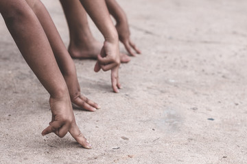 Children hand are preparing to race.