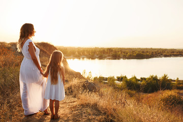 Mother and daughter are looking at the river