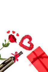 Present for Valentine day in red colors. Wine, rose, heart sign, gift box on white background top view copy space