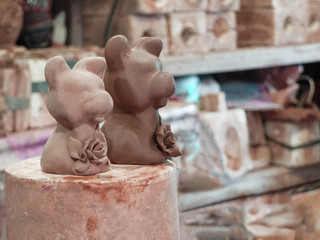Еущ clay figurines of dogs handcrafted in the workplace.  Raw and dry clay.